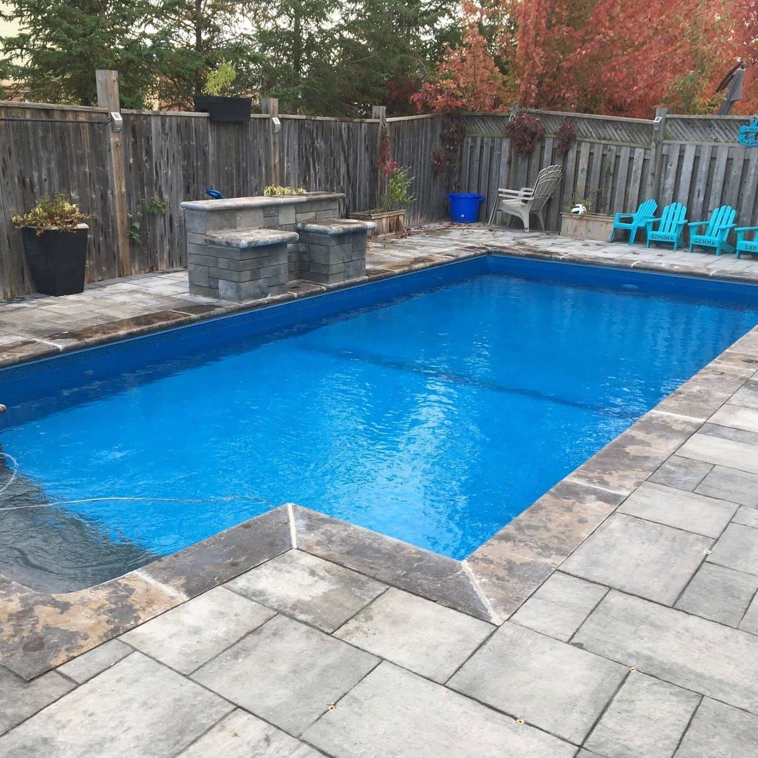 Rectangular inground pool with a stone and concrete patio